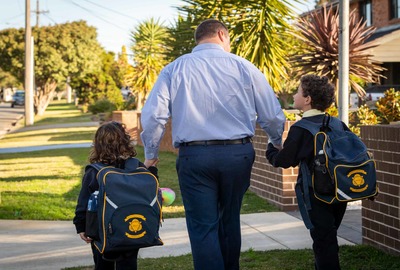 Sydney Catholic Schools Road Safety Education Officer, Andrew Sortwell, walking with his children.