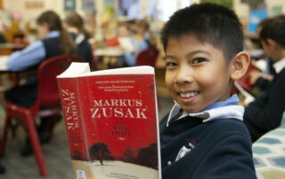 A boy from St Charles' literature enrichment group reads 'The Book Thief'