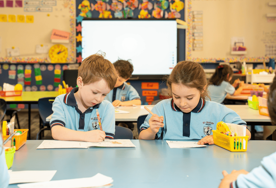 A photo of two students reading books in the library at St Charles' School Waverley